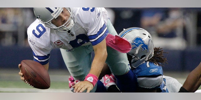 Oct 2: Detroit Lions defensive end Willie Young, right, brings down Dallas Cowboys quarterback Tony Romo (9) in the final minutes of an NFL football game in Arlington, Texas. The Lions won 34-30. (AP Photo/Tony Gutierrez)