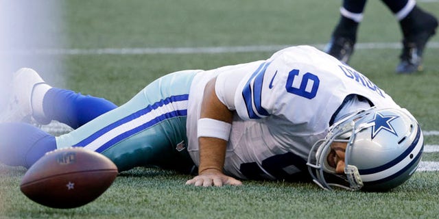 Dallas Cowboys quarterback Tony Romo lies on the turf after he went down on a play against the Seattle Seahawks during the first half of a preseason NFL football game, Thursday, Aug. 25, 2016, in Seattle. (AP Photo/Elaine Thompson)