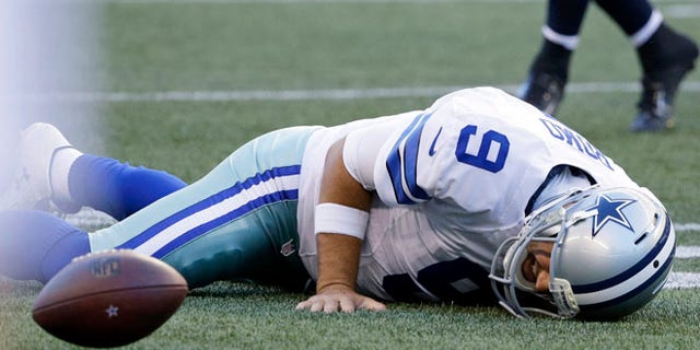 Dallas Cowboys quarterback Tony Romo lies on the turf after he went down on a play against the Seattle Seahawks during the first half of a preseason NFL football game, Thursday, Aug. 25, 2016, in Seattle. (AP Photo/Elaine Thompson)