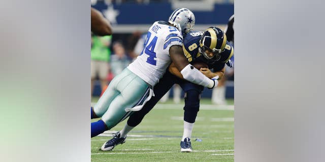 File - In this Sept. 22, 2013, file photo, Dallas Cowboys defensive end DeMarcus Ware (94) sacks St. Louis Rams quarterback Sam Bradford (8) during the third quarter of an NFL football game, in Arlington, Texas. The Cowboys are releasing franchise sacks leader Ware to save salary cap room after the worst season of his career. (AP Photo/LM Otero, File)