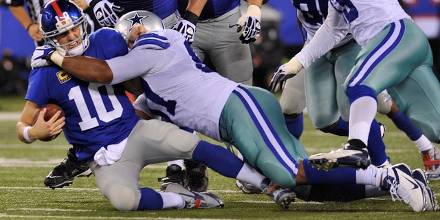 Sept. 5, 2012: New York Giants quarterback Eli Manning (10) is sacked by Dallas Cowboys defensive end Jason Hatcher (97) during the second half of an NFL football game.