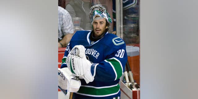 Vancouver Canucks goalie Ryan Miller prepares to leave the bench following the Canucks loss to the Arizona Coyotes in Vancouver, British Columbia, Monday, Sept. 29, 2014. (AP Photo/The Canadian Press, Jonathan Hayward)