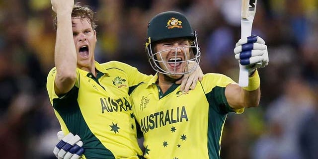 March 29, 2015: Australia's Steve Smith, left, and teammate Shane Watson celebrate after defeating New Zealand by seven wickets to win the Cricket World Cup final in Melbourne, Australia.