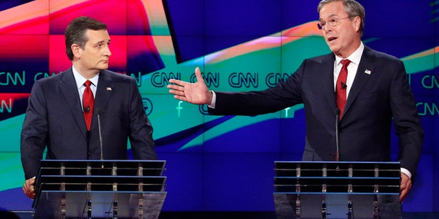 FILE - In this Dec. 15, 2015 file photo, former Florida Gov. Jeb Bush, right, makes a point as Sen. Ted Cruz, R-Texas listens on during the Republican presidential debate in Las Vegas. Ted Cruz once proudly wore a belt buckle reading President of the United States borrowed from George H.W. Bush. He campaigned and worked for, and helped write a book lavishing praise on, that former presidents son, Dubya. And the endorsement of George P. Bush, the familys latest rising political star, lent credibility to Cruzs then little-known 2012 Senate campaign. (AP Photo/John Locher, File)