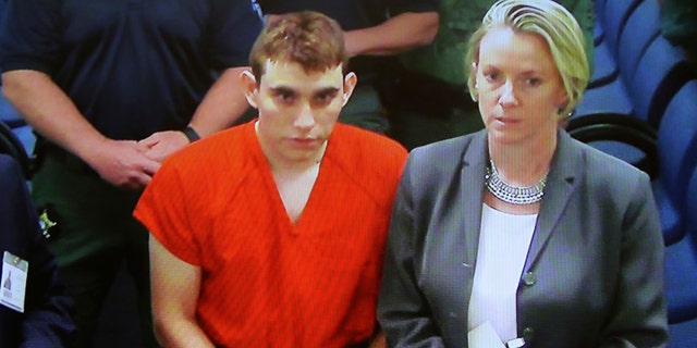 Nikolas Cruz is seen during a hearing flanked by his lawyer Diane Cuddihy.