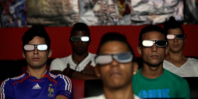 People watch a 3D movie at a private movie theater in Havana, Cuba, Monday, Oct. 28, 2013. Cuban entrepreneurs have quietly opened dozens of backroom video salons over the last year, seizing on ambiguities in licensing laws to transform cafes and childrenâs entertainment parlors into a new breed of private business unforeseen by recent official openings in the communist economy. (AP Photo/Franklin Reyes)