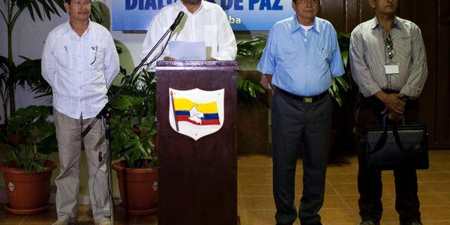 FILE - In this Feb. 28, 2014 file photo, Ivan Marquez, chief negotiator for the Revolutionary Armed Forces of Colombia, or FARC, center, speaks to journalists accompanied by Commander Fabian Ramirez, left, and Commanders Jairo Martinez, second from right and Fidel Rondon, during the continuation of peace talks with Colombia's government in Havana, Cuba. The FARC issued a statement issued Wednesday, May 27, 2015 that said the man known by the alias Jairo Martinez was among 27 rebel fighters killed during an attack on a guerrilla camp in southwest Colombia last week. The FARC says Martinez was visiting troops to discuss progress at the peace talks when they were surprised by the air and ground assault. Martinez’s real name is Pedro Nel Daza. (AP Photo/Franklin Reyes, File)