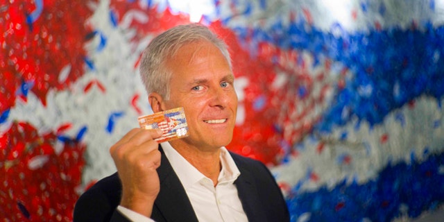 In this June 8, 2016 photo, Stonegate Bank President David Seleski poses with a credit card during an interview in Havana, Cuba. Stonegate, a small Florida bank, will issue the first U.S. credit card designed to work in Cuba on Wednesday, June 15, making it easier for American companies to do business on an island largely cut off from the U.S. financial system. (AP Photo/Ramon Espinosa)