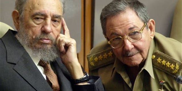 Fidel and Raul Castro, in a 2004 file photo.