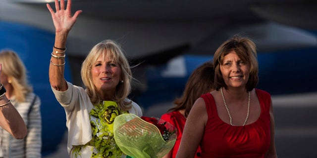 Dr. Jill Biden, wife of United States Vice President Joe Biden, waves as she walks next to the Director General of the U.S. division at Cuba's Foreign Ministry, Josefina Vidal, right, on the tarmac of Jose Marti International Airport in Havana, Cuba, Thursday, Oct. 6, 2016. Biden is on a three day visit to Cuba. (Ismael Francisco/Cubadebate via AP)