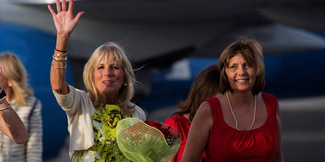 Dr. Jill Biden, wife of United States Vice President Joe Biden, waves as she walks next to the Director General of the U.S. division at Cuba's Foreign Ministry, Josefina Vidal, right, on the tarmac of Jose Marti International Airport in Havana, Cuba, Thursday, Oct. 6, 2016. Biden is on a three day visit to Cuba. (Ismael Francisco/Cubadebate via AP)