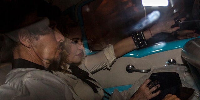 US performer Madonna rides in a classic American car on the way into a landmark private restaurant for a party in Havana, Cuba, Tuesday, Aug. 16, 2016. Madonna is on a private visit to Cuba to celebrate her 58th birthday. (AP Photo/Desmond Boylan)