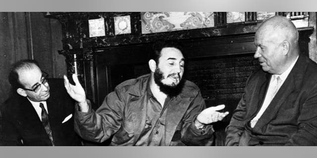 In this Sept. 20, 1960 photo, Cuba's leader Fidel Castro, center, speaks with Soviet Premier Nikita Khrushchev, right, as his Foreign Minister Raul Roa, left, looks on at the Hotel Theresa during the United Nations General Assembly in New York. The world stood at the brink of Armageddon for 13 days in October 1962 when President John F. Kennedy drew a symbolic line in the Atlantic and warned of dire consequences if Soviet Premier Nikita Khrushchev dared to cross it. On the eve of the 50th anniversary of the Cuban missile crisis, historians now say it was behind-the-scenes compromise rather than a high-stakes game of chicken that resolved the faceoff, that both Washington and Moscow wound up winners and that the crisis lasted far longer than 13 days. (AP Photo/Prensa Latina via AP Images)