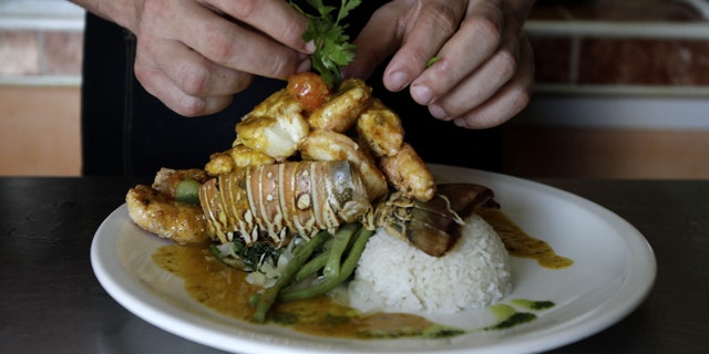 In this photo taken Friday, April 29, 2011, chef Diomer Matos prepares "Esclava de Langosta," a lobster dish, at La Moneda Cubana, a private restaurant, in Old Havana, Cuba. A restaurant boom is sweeping Havana under new rules that make it easier to run "paladars," with a wave of new private eateries opening since January 2011. (AP Photo/Franklin Reyes)