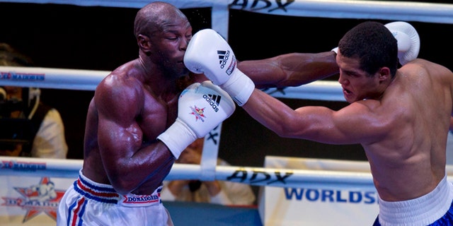 Cuban boxer Emilio Correa, left, receives a punch from Michel Borges de Souza of the U.S. during their men's 81kg boxing match in Havana, Cuba, Friday, April. 4, 2014. Boxers from the U.S. and Cuba went glove-to-glove on Cuban soil for the first time in 27 years Friday in a semipro World Series of Boxing clash (AP Photo/Ramon Espinosa)