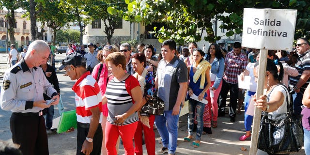 People queue for visas at the U.S. Interests Section in Havana, Cuba, Monday, Dec. 22, 2014.