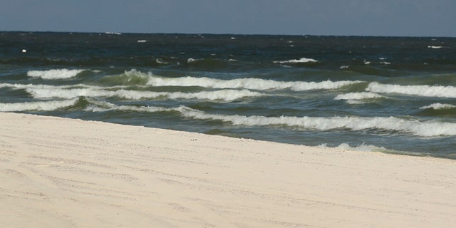 GULF SHORES, AL - JULY 04: Julie Wonder on vacation from Czechoslovakia enjoys an empty beach as people stayed away due to the threat of contamination from the Deepwater Horizon oil spill in the Gulf of Mexico on July 4, 2010 in Gulf Shores,Alabama. The oil spill may have a huge negative economic impact on gulf coast businesses during what should be a busy 4th of July. Millions of gallons of oil have spilled into the Gulf since the April 20 explosion on the drilling platform. (Photo by Joe Raedle/Getty Images) *** Local Caption *** Julie Wonder