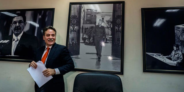 Gustavo Machin, Cuba's deputy chief of North American affairs, speaks to reporters in at the Foreign Ministry in Havana, Cuba, Thursday, May 12, 2016, ahead of Monday's meeting between U.N. representatives from the United States and Cuba. Behind are pictures of Cuba's President Raul Castro, left, his brother Fidel Castro, center, and rebel leader Ernesto "Che" Guevara speaking at the U.N. in 1964. (AP Photo/Ramon Espinosa, Pool)