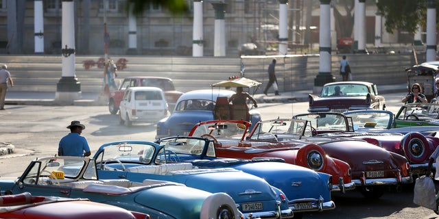 HAVANA, CUBA - FEBRUARY 28:  Vintage American automobiles are seen on the street as their owners wait for tourists wanting a ride a day after the second round of diplomatic talks between the United States and Cuban officials took place in Washington, DC on February 28, 2015 in Havana, Cuba.  The dialogue is an effort to restore full diplomatic relations and move toward opening trade.  (Photo by Joe Raedle/Getty Images)