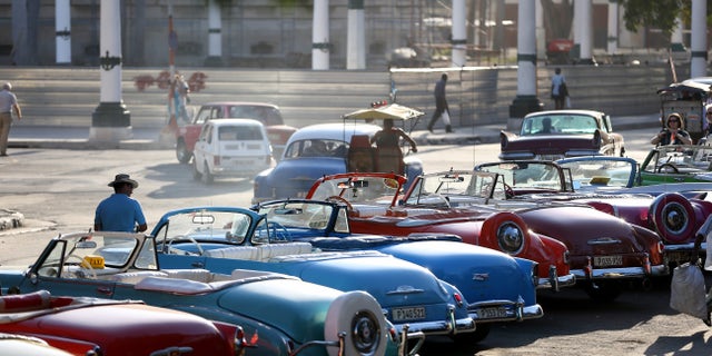 HAVANA, CUBA - FEBRUARY 28: Vintage American automobiles are seen on the street as their owners wait for tourists wanting a ride a day after the second round of diplomatic talks between the United States and Cuban officials took place in Washington, DC on February 28, 2015 in Havana, Cuba. The dialogue is an effort to restore full diplomatic relations and move toward opening trade. (Photo by Joe Raedle/Getty Images)