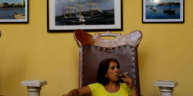 August 25: A woman smokes a cigarette in Havana, Cuba. A program that provided state subsidized smokes to Cuban seniors is going up in smoke. The communist government announced Wednesday it is cutting cigarettes from its monthly ration books effective Sept. 1, the latest step toward keeping potentially risky promises to fully eliminate subsidies on food and other basics which many impoverished islanders depend on. (AP)