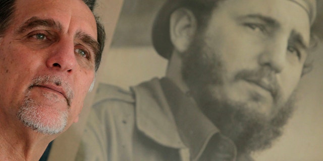 In this Feb. 17, 2014 photo, Rene Gonzalez, the Cuban Five," poses for a portrait under a framed picture of Fidel Castro in Havana, Cuba. Gonzalez was an unknown young pilot in 1990 when he pretended to steal a crop duster in Cuba and flew to Florida, using cover as a Cuban defector to spy on targets in the United States. The Cuba Five refers to intelligence agents in the employ of Fidel Castro's Cuba, they were arrested in the United States in 1998 and given terms ranging from 15 years to consecutive life sentences on charges including conspiracy and failure to register as foreign agents. (AP Photo/Franklin Reyes)
