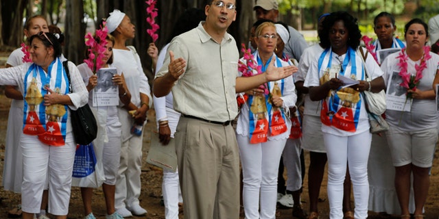 Cuban dissident Antonio Rodiles speaks during a gathering of Cuba's dissident group Ladies in White in Havana, Cuba, Sunday Dec. 28, 2014. Cubaâs government has long narrowly defined the bounds of acceptable speech, accusing many dissidents of being as agents of the U.S. government or right-wing exile groups, and subjecting them to surveillance, temporary detention and harassment. Advocates of a softer line usually receive less harsh treatment. (AP Photo/Desmond Boylan)