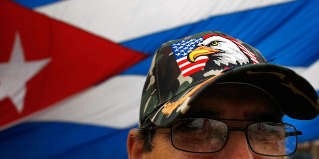 MIAMI - FEBRUARY 19: Ramiro Naval wears an American flag hat as he reacts to the news that Cuban President Fidel Castro announced he will not accept a new term in office in front of the Versailles restaurant in the Little Havana neighborhood February 19, 2008 in Miami, Florida. Castro has announced he is stepping down after 49 years in power, saying he is no longer healthy enough to hold office. (Photo by Joe Raedle/Getty Images)