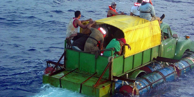 AT SEA - JULY 24: In this U.S. Coast Guard handout, Cuban migrants trying to reach the U.S. coast in Florida ride a makeshift boat made out of a 1951 Chevrolet truck with a propeller driven off the drive shaft July 16, 2003 off the coast of Florida. The U.S. Coast Guard Cutter Key Largo returned the12 Cuban migrants from the vessel back to Cuba after making it within 40 miles of Key West, Florida. The photograph was released a week after the crew was repatriated. (Photo by Gregory Ewald/ U.S. Coast Guard/ Getty Images)