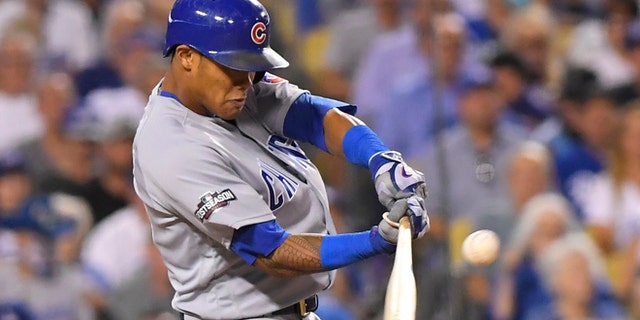 Chicago Cubs' Addison Russell hits a two-run home run off Los Angeles Dodgers relief pitcher Joe Blanton during the sixth inning of Game 5 of the National League baseball championship series Thursday, Oct. 20, 2016, in Los Angeles. (AP Photo/Mark J. Terrill)