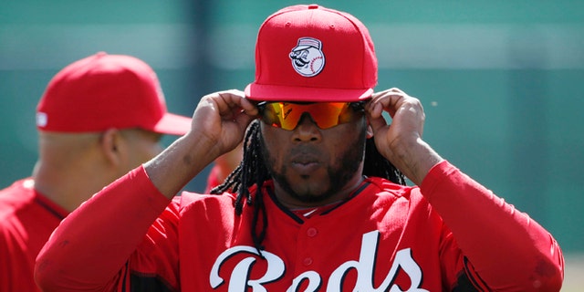 Cincinnati Reds' player Johnny Cueto adjusts his sunglasses during the team's first day of spring training practice Thursday, Feb. 19, 2015, in Goodyear, Ariz. (AP Photo/John Locher)