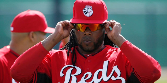 Cincinnati Reds' player Johnny Cueto adjusts his sunglasses during the team's first day of spring training practice Thursday, Feb. 19, 2015, in Goodyear, Ariz. (AP Photo/John Locher)