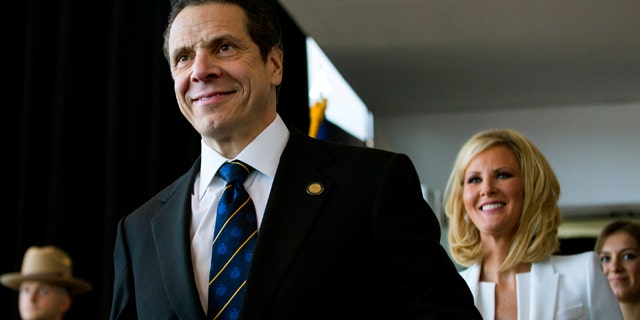 Jan. 1, 2015: New York Gov. Andrew Cuomo arrives for his inaugural ceremony at One World Trade Center in New York. At right is Cuomo's girlfriend Sandra Lee. (AP Photo/Craig Ruttle, Pool)