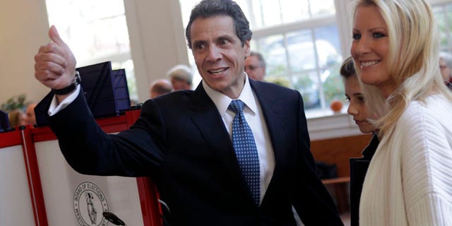 Nov. 2: Andrew Cuomo gives a thumbs-up after voting while his daughter Michaela Cuomo, center, and his girlfriend Sandra Lee look on in Mt. Kisco, N.Y.