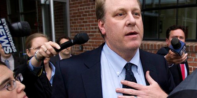 May 16, 2012: Former Boston Red Sox pitcher Curt Schilling, center, is followed by members of the media as he departs the Rhode Island Economic Development Corporation headquarters, in Providence, R.I.