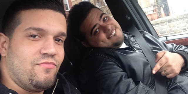 In this undated photo provided by the United States Attorneyâs Office for the Southern District of New York, Elvis Rafael Rodriguez, left, and Emir Yasser Yeje, pose with bundles of cash allegedly stolen using bogus magnetic swipe cards at cash machines throughout New York. (AP Photos/U.S. Attorneyâs Office for the Southern District of New York)