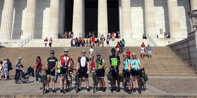 In this June 1, 2015 photo provided by Drew Bent, seven students from Harvard and MIT pose with their bicycles at the Lincoln Memorial in Washington. The seven are participating in a project called Spokes and are cycling across America, stopping in many rural towns to get students interested in science through hands-on workshops. (Courtesy of Drew Bent via AP)