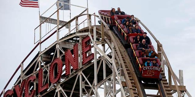 Oct. 27, 2012: People ride the famous wooden roller coaster "Cyclone", at Coney Island, New York.