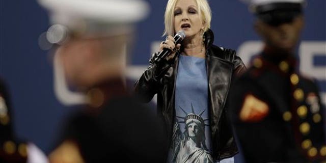 Sept. 10: Cyndi Lauper, center, performs during a ceremony to honor the victims of the Sept. 11 attacks at the U.S. Open tennis tournament in New York. (AP)