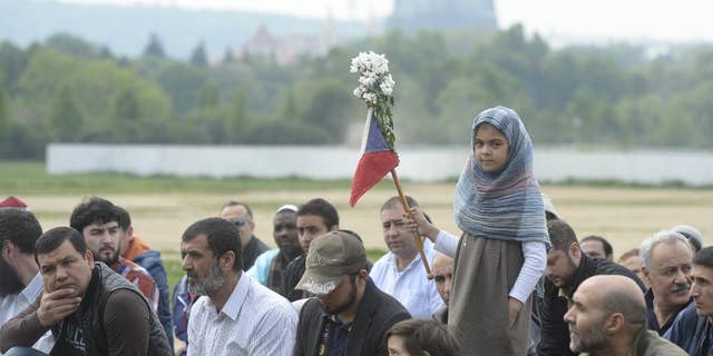 Muslims living in the Czech Republic pray in front a headquarters of the Ministry of Interior to protest against a police raid in an Islamic center in the Czech capital last week in Prague, on Friday, May 2, 2014. Czech churches have sided with local Muslims who have complained about police raids in Islamic centers during prayers. The raids took place last Friday in Prague as police arrested a 55-year-old Czech who was charged with racism for publishing an Islamic book that police alleged spreads racism, anti-Semitism, xenophobia and violence against "inferior races.” (AP Photo/CTK, Michal Krumphanzl) SLOVAKIA OUT