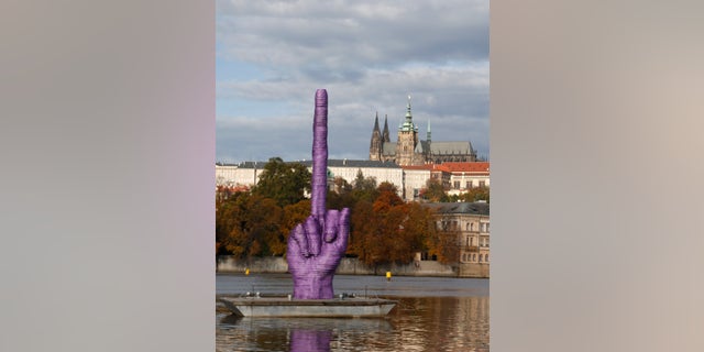 Oct. 21, 2013 - A statue by Czech sculptor David Cerny is placed on the Vltava river in Prague, Czech Republic. A Czech artist known for his anti-communist stance floated the statue days before parliamentary elections that could give the communists a taste of power.