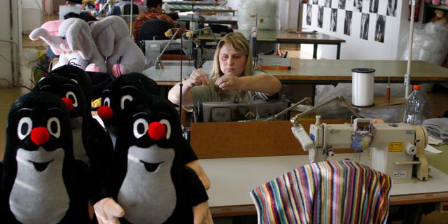 Nov. 9, 2011: A worker adjusts her sewing machine at the toy factory in Brno, Czech Republic. As Europe's economic crisis bites, toy manufacturers here are thriving. Profits are high, new markets are opening and Little Mole, a cartoon character created in 1956 and still going strong, is the unrivaled star.