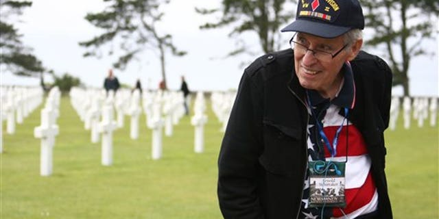 WWII veteran Arnold Whittaker of Atlanta — of the 3rd Army, 5th Infantry Division, 10th Infantry Regiment Company K — is shown visiting the U.S military cemetery in Colleville sur Mer, western France, on June 6, 2011.
