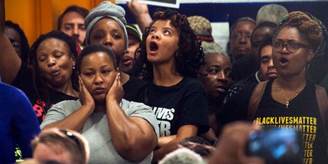 Aug. 27, 2015: People react as Washington D.C. Mayor Muriel Bowser addresses the rise in violent crime in DC during a news conference at the former Malcolm X Elementary School in Congress Heights in Washington, D.C.