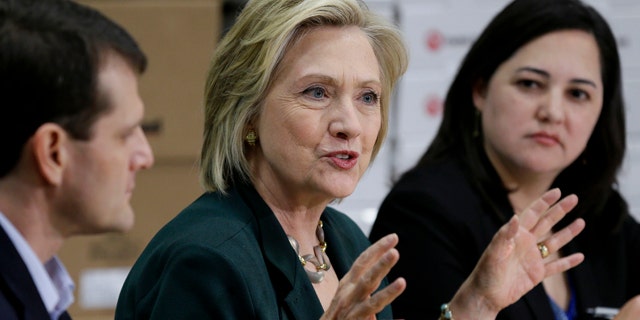 April 15, 2015: Democratic presidential candidate Hillary Rodham Clinton, center, speaks during a small business roundtable in Norwalk, Iowa. (AP Photo/Charlie Neibergall)