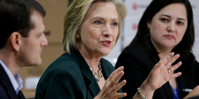April 15, 2015: Democratic presidential candidate Hillary Rodham Clinton, center, speaks during a small business roundtable in Norwalk, Iowa. (AP Photo/Charlie Neibergall)