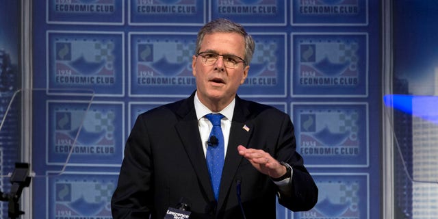 FILE - In this Feb. 4, 2015 file photo, former Florida Gov. Jeb Bush speaks at a Economic Club of Detroit meeting in Detroit. To Democrats, Jeb Bush offers an inviting target reminiscent of Mitt Romney's 2012 presidential campaign: Both opposed the government's rescue of U.S. automakers. Both worked in finance and backed the Wall Street bailout. Both have advocated for tax cuts that Democrats contend benefit the wealthy and big business. Starting the 2016 campaign, Democrats want to turn the former Florida governor into a carbon copy of Romney, who struggled against an onslaught of criticism related to his work in private equity and his portrayal by President Barack Obama's allies as a cold-hearted plutocrat. (AP Photo/Paul Sancya, File)