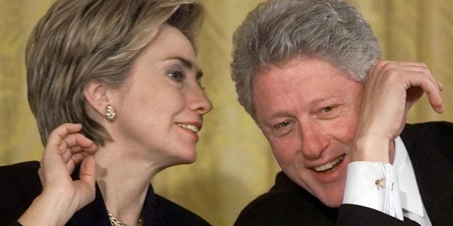 FILE - In this Oct. 22, 1999 file photo, President Bill Clinton and first lady Hillary Rodham Clinton talk during the White House Conference on Philanthropy in the East Room of the White House in Washington. As first lady in the final year of the Clinton administration, Hillary Rodham Clinton approved the unveiling of a White House plan to push for tax breaks for private foundations and wealthy charity donors at the same time that the William J. Clinton Foundation was soliciting donations for her husbands presidential library, recently-released Clinton-era documents show. (AP Photo/Khue Bui, File)