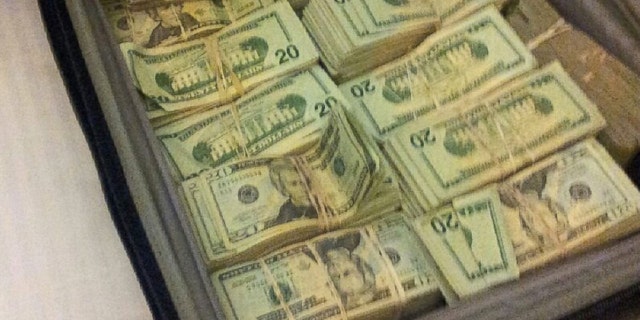 A satchel of money officials allege was found on the defendants when they were arrested. (Department of Justice)