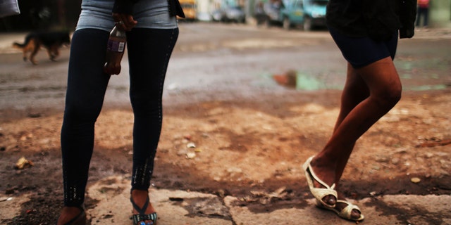 TEGUCIGALPA, HONDURAS - JULY 18: Sex workers wait for customers in a gang infested neighborhood on July 18, 2012 in Tegucigalpa, Honduras. Honduras now has the highest per capita murder rate in the world and its capital city, Tegucigalpa, is plagued by violence, poverty, homelessness and sexual assaults. With an estimated 80% of the cocaine entering the United States now being trans-shipped through Honduras, the violence on the streets is a spillover from the ramped rise in narco-trafficking. The non-governmental organization Doctors Without Borders has set up a program in the capital that looks to provide medical and psychological care to the homeless population. Each day a team goes out into the streets to meet with vulnerable groups of homeless to assess their needs. (Photo by Spencer Platt/Getty Images)